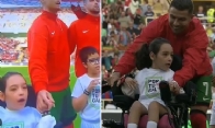 Cristiano Ronaldo helps disabled child onto pitch 